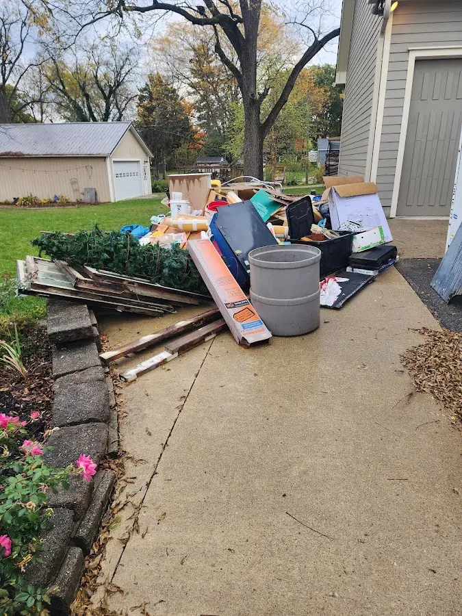 Dumpster being loaded with debris for Residential Dumpster Rental in Roseville